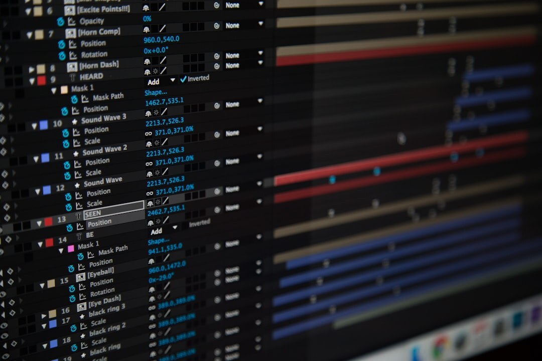 Video editor working at an editing bay with multiple monitors