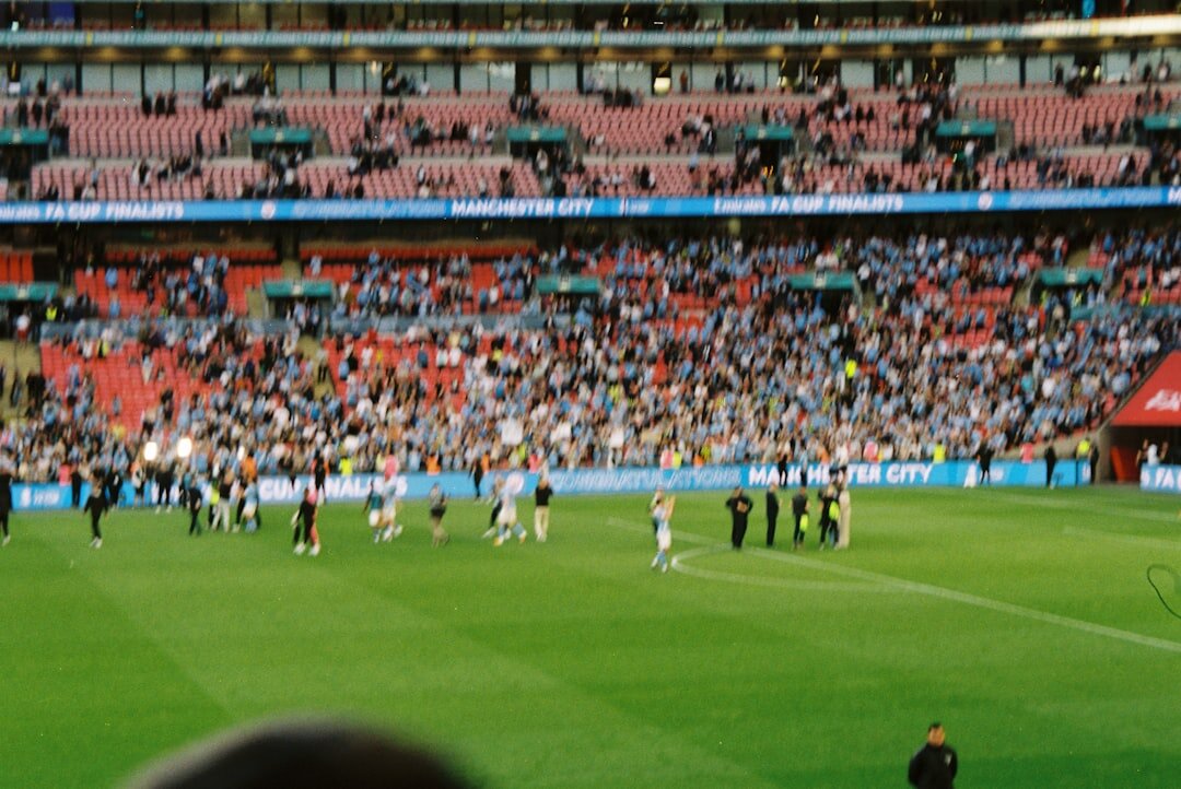 Camera operators filming live sports coverage in a stadium