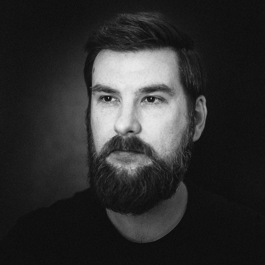 Studio portrait of a man technical producer in a collared shirt